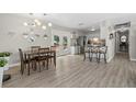 Dining area showcasing new floors, open layout and seating with view of fenced backyard at 4009 Yucatan Cir, Port Charlotte, FL 33948