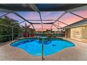 Inviting screened pool and spa area with outdoor seating, perfect for relaxation and entertaining at 5010 La Costa Island Ct, Punta Gorda, FL 33950