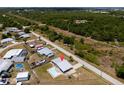 An aerial view showcasing the property's layout, including the pool, fenced yard, and surroundings at 5527 Fairway S Dr, Punta Gorda, FL 33982