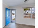Bright entryway featuring a vibrant blue front door and modern, durable wood-look floors at 6336 Drucker Cir, Port Charlotte, FL 33981
