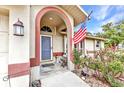 Welcoming front porch with American flag and decorative accents, creating a cozy entrance at 6371 Mckinley Ter, Englewood, FL 34224