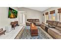 Spacious living room with tile floors, comfortable seating, and natural light from the windows at 6371 Mckinley Ter, Englewood, FL 34224