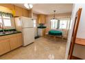 Kitchen with light wood cabinets, green countertops, and a bright eating nook at 643 Blackburn Blvd, North Port, FL 34287