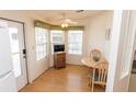 Cozy dining area featuring a table with chairs, ample natural light, and an exterior door at 713 Riverview Cir, North Port, FL 34287