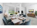 Dining room featuring a marble table and seating for six at 8488 Saint Kitts Cir, Englewood, FL 34224