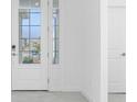 Bright foyer with tile flooring and glass front doors at 8488 Saint Kitts Cir, Englewood, FL 34224