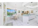 Bright kitchen and breakfast nook with white cabinetry and a view of the pool at 910 Via Tripoli, Punta Gorda, FL 33950