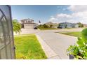 Neighborhood street view showcasing well-maintained homes and landscaped front yards on a sunny day at 10068 Winding River Rd, Punta Gorda, FL 33950