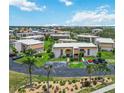 Aerial view of condo complex with lush landscaping, ample parking, and well-maintained buildings under a sunny sky at 1080 Bal Harbor Blvd # 11C, Punta Gorda, FL 33950