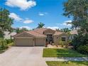 Stunning home with tile roof, three-car garage, and pristine landscaping at 11982 Granite Woods Loop, Venice, FL 34292