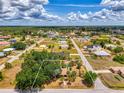 Wide aerial view showcasing property lines in a quiet residential neighborhood at 12018 Saragossa Ln, North Port, FL 34287