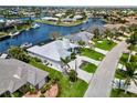 Waterfront property with lush landscaping, boat dock, and screened-in lanai in an upscale neighborhood at 1306 Osprey Dr, Punta Gorda, FL 33950