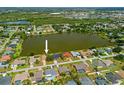 Aerial view of a waterfront property featuring a private lake, mature trees, and established neighborhood at 158 Norman St, Port Charlotte, FL 33954