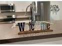 Close-up of modern kitchen sink with stainless steel appliances in background at 25324 Aysen Dr, Punta Gorda, FL 33983