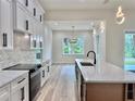 The kitchen island has a marbled top and a stainless steel sink at 2743 Begonia Ter, North Port, FL 34286