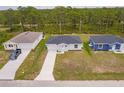 An aerial view of three single-Gathering homes showcasing their modern design and community setting at 27438 Corinthian Dr, Punta Gorda, FL 33955