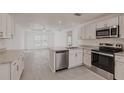 Bright kitchen with white cabinets, stainless steel appliances, and granite countertops at 27438 Corinthian Dr, Punta Gorda, FL 33955