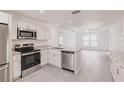 Modern kitchen featuring stainless steel appliances and granite countertops at 27444 Corinthian Dr, Punta Gorda, FL 33955