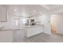 Bright kitchen featuring stainless steel appliances, granite countertops, white cabinets and gray floors at 27456 Corinthian Dr, Punta Gorda, FL 33955