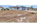 Charming single-story home featuring a new driveway and attached one car garage at 3380 Elkcam Blvd, Port Charlotte, FL 33952