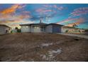 Charming single-story home featuring a new driveway and attached one car garage at sunset at 3380 Elkcam Blvd, Port Charlotte, FL 33952