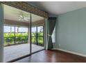 Bright bedroom with access to a screened lanai overlooking a beautiful outdoor view at 3702 Lakewood Blvd, North Port, FL 34287