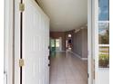 Inviting foyer that leads into a spacious living room with neutral colors and tile flooring at 4027 Quaker Ln, North Port, FL 34288