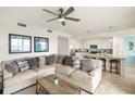 Open-concept living room featuring modern decor, an eat-in kitchen and a comfortable sofa at 43030 Greenway Blvd # 426, Punta Gorda, FL 33982