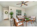 Covered outdoor patio seating area with stylish ceiling fan and decor at 43984 Boardwalk Loop # 1726, Punta Gorda, FL 33982