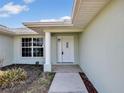Inviting entryway featuring a decorative front door and a tiled walkway at 5331 Citadel Rd, Venice, FL 34293