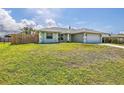 Well-maintained home featuring a lush green lawn and privacy fence at 5331 Citadel Rd, Venice, FL 34293