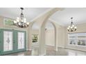 Bright foyer with arched entryways and decorative lighting, creating an elegant and welcoming entrance at 8183 Deland St, Port Charlotte, FL 33981