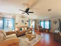 Inviting living room with wood floors, comfortable seating, and stylish decor, creating a warm ambiance at 857 Seabrooke Dr, Englewood, FL 34223
