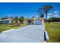 Delightful single-story home with an attached one-car garage and an expansive driveway providing ample parking at 900 Stewart St, Englewood, FL 34223