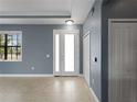 Entryway featuring neutral tile floors, blue walls, a closet and a bright white front door with sidelight at 97 Pine Valley Ln, Rotonda West, FL 33947