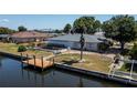 Waterfront property with a private dock and fenced backyard, perfect for outdoor living and relaxation at 110 Colonial Sw St, Port Charlotte, FL 33952