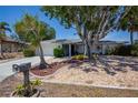 Charming home featuring mature trees and landscaping, enhancing curb appeal and providing shade at 110 Colonial Sw St, Port Charlotte, FL 33952