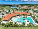 A high aerial of a community pool and recreation area, with lounge seating at 11819 Sistine Ln, Venice, FL 34293