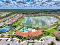 Aerial shot of the community pool, tennis courts, clubhouse, and playground at 11819 Sistine Ln, Venice, FL 34293