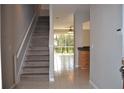 Inviting entryway with staircase and views of the living area and screened-in patio at 1271 Jonah Dr, North Port, FL 34289