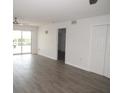 Open-concept living room features wood flooring, neutral walls, a sliding glass door, and closets at 150 Harborside Ave # 124, Punta Gorda, FL 33950