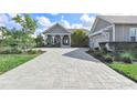 Charming home featuring a meticulously paved driveway and inviting front porch with elegant white columns at 17213 Bullhorn Cir, Punta Gorda, FL 33982