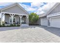 Inviting home featuring a paved driveway, complemented by a cozy front porch perfect for relaxation at 17213 Bullhorn Cir, Punta Gorda, FL 33982