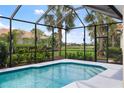Screened-in pool with sunny patio and lush tropical landscaping at 181 Padova Way # 19, Nokomis, FL 34275