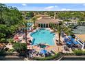 Beautiful community pool area with palm trees, lounge chairs, and plenty of space for recreation at 181 Padova Way # 19, Nokomis, FL 34275