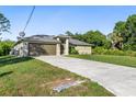 Well-maintained single-story home with a paved driveway and a lovely lawn and attached two car garage at 2381 Sheila Ln, North Port, FL 34286