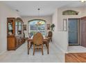 Bright dining room features tile flooring, a large window, and a classic wooden hutch at 24371 Folkstone Ave, Punta Gorda, FL 33980