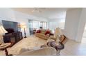 Inviting living room featuring neutral tones, tile flooring, and comfortable seating arrangements at 26089 Seminole Lakes Blvd, Punta Gorda, FL 33955