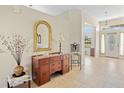 Foyer featuring tile flooring, a decorative mirror and dark wood console table with drawers at 27038 San Jorge Dr, Punta Gorda, FL 33983