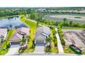 Stunning aerial view of the home showcasing its prime location near a lake and community pathway at 281 Potenza Loop, Nokomis, FL 34275